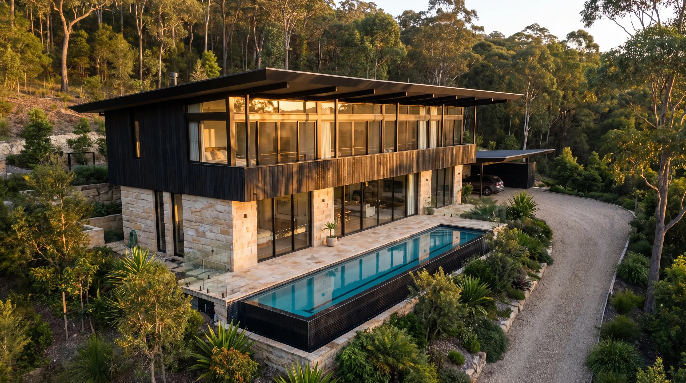 Ferny Creek, a two-storey blackened timber and sandstone home with a lap pool.